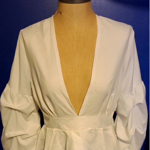 Chic Elegance Ivory Plunging Peplum Blouse - Picture 1 of 5
